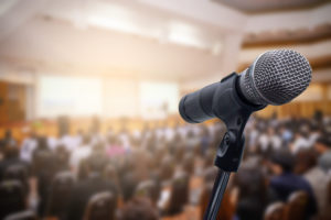 Microphone over the blurred business people forum Meeting Conference Training Learning Coaching Concept, Blurred background.