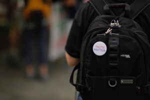 Backpack with pin on it saying