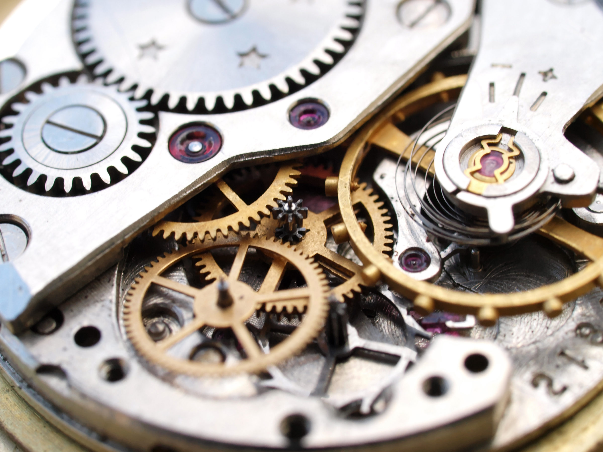 close up macro pic of vintage watch mechanism gears